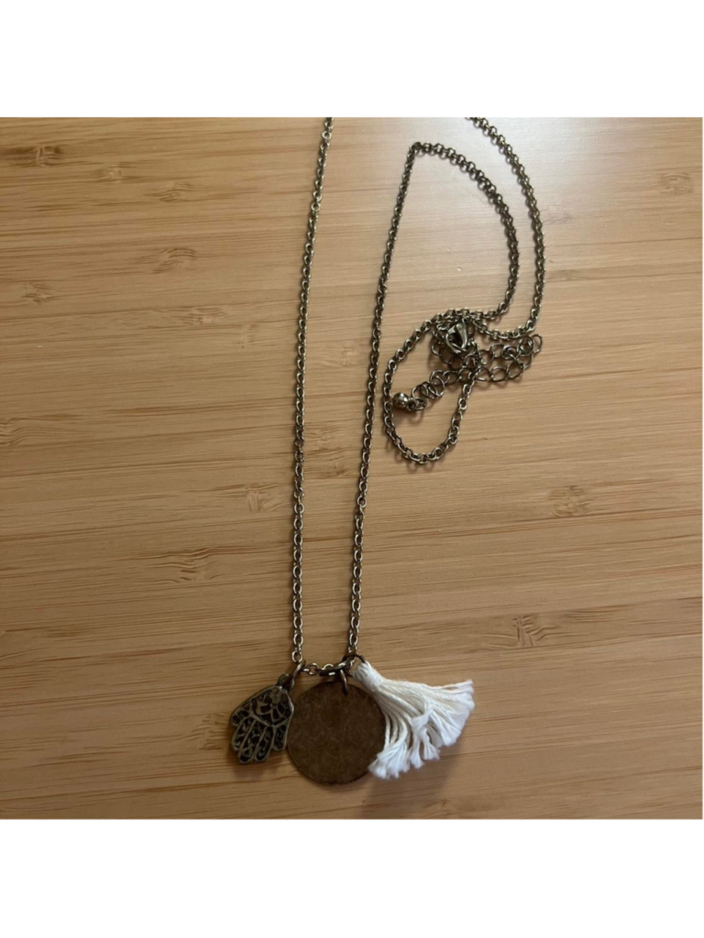 Long gold/bronze necklace with hamsa charm